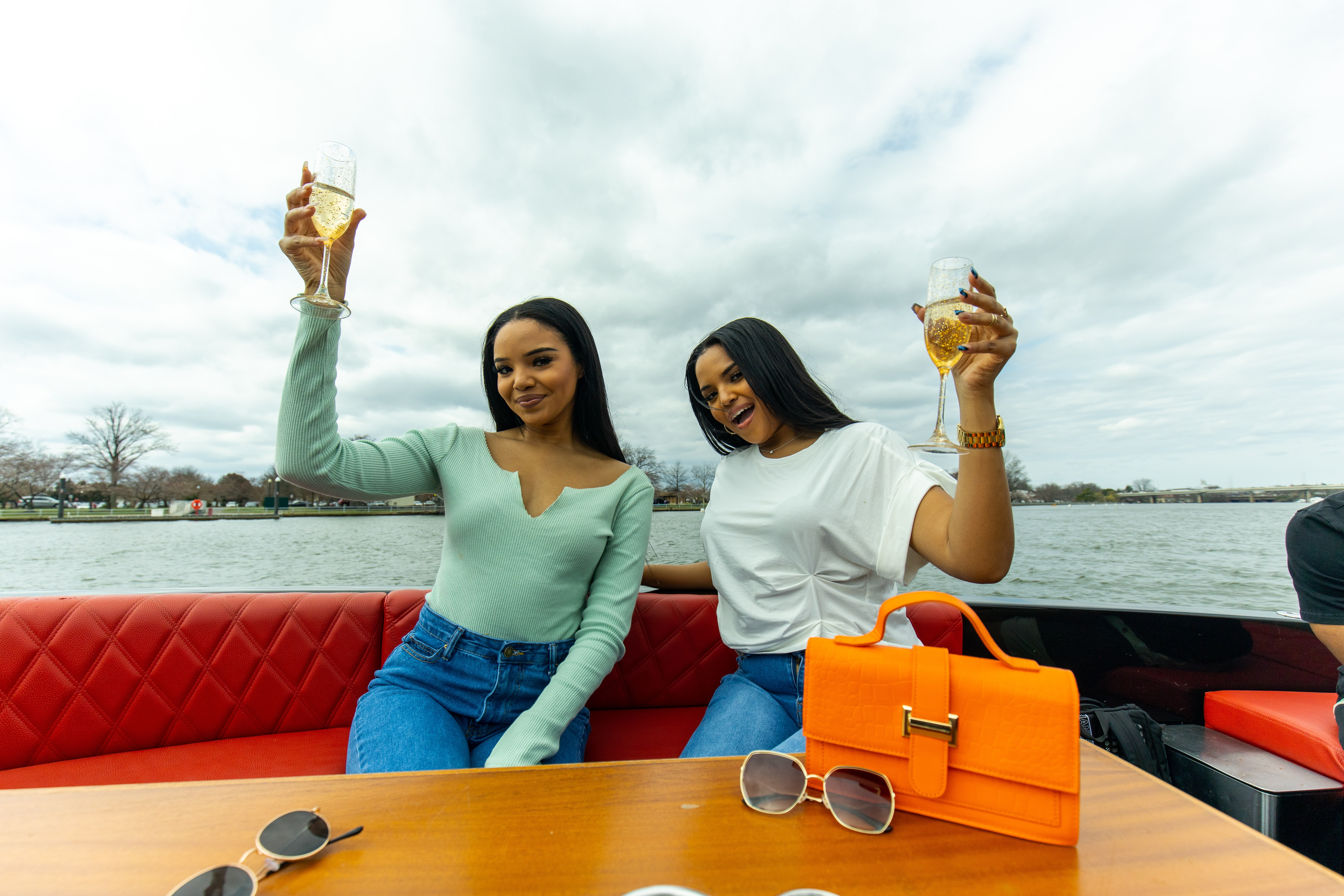 Friends celebrating together on a Yachtsy cruise at sunset