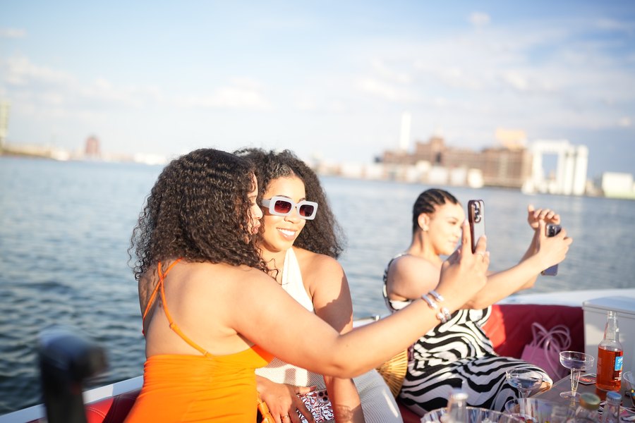 A group of friends toasting drinks in the sunshine on a private Yachtsy cruise