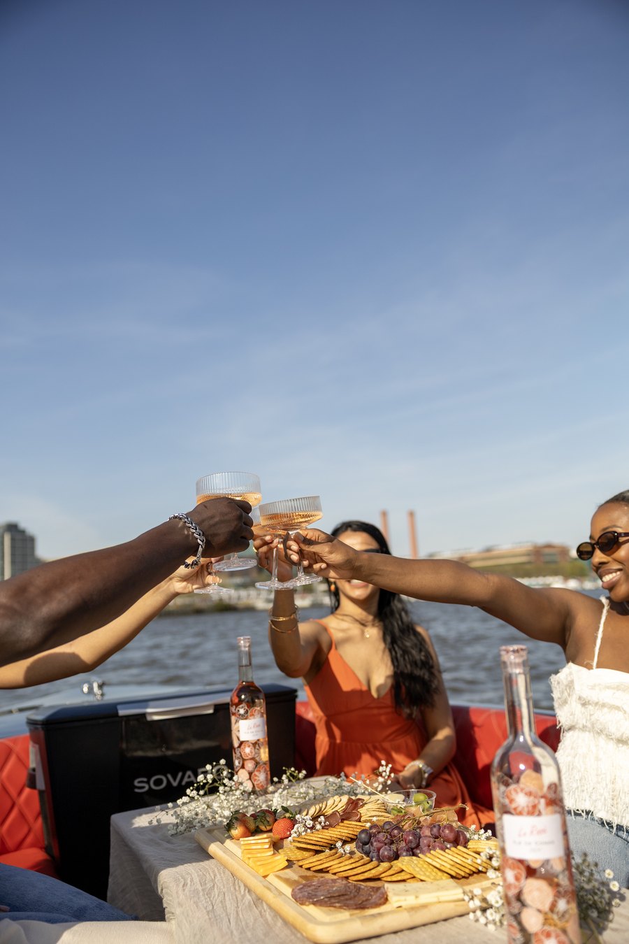 Guests toasting over a spread of food and drinks on a Yachtsy picnic cruise