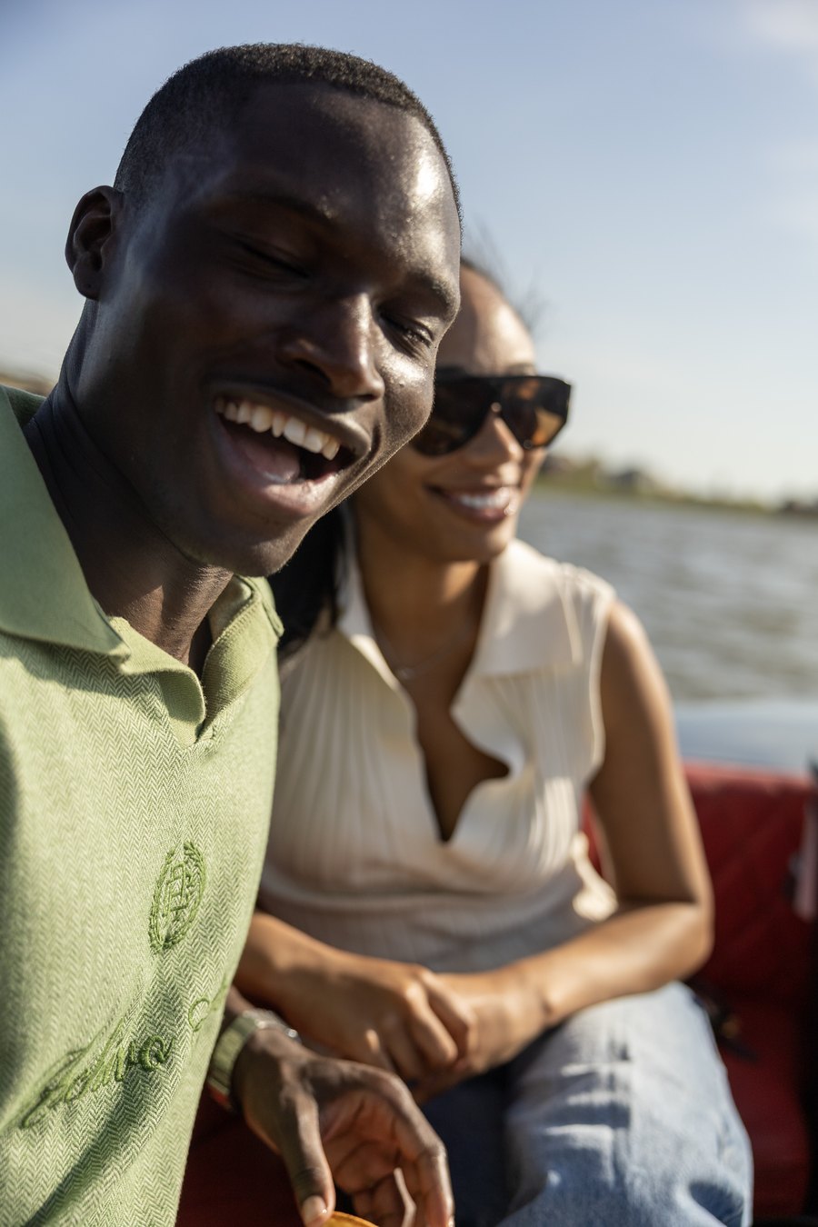 A guest laughing at golden hour during a private Yachtsy boat cruise