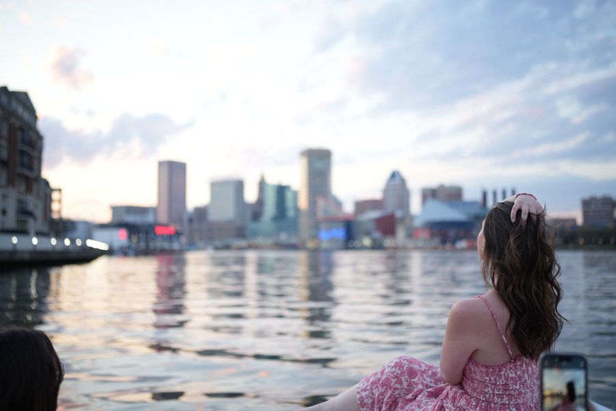A guest watching the Inner Harbor skyline from a private Yachtsy cruise